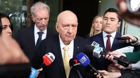 Sexual Assault Charges Against Leading Aussie Media Personality Downgraded